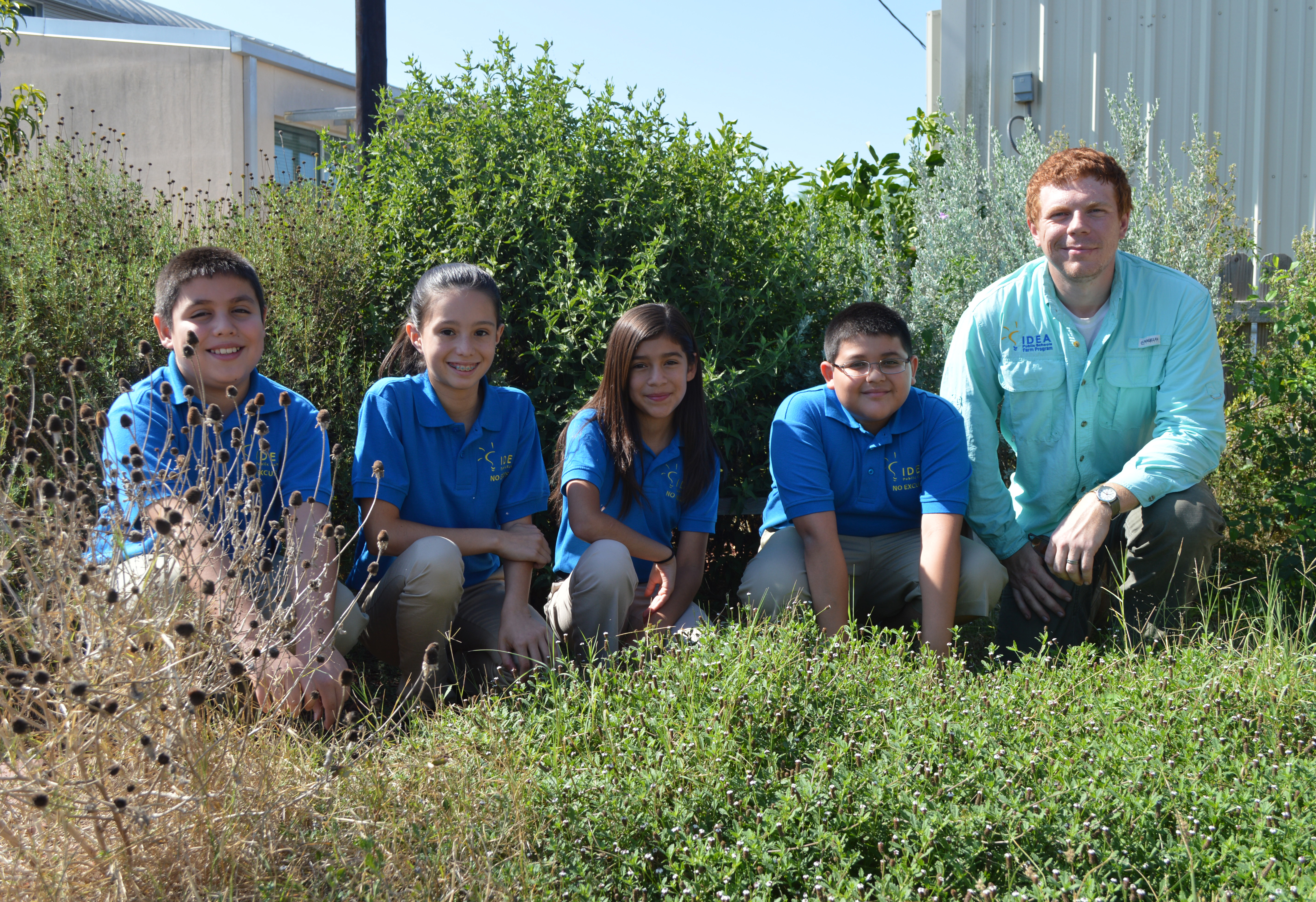 Justin Tuley with a group of fourth-grade students on the school farm on the Donna, Texas, campus. Photo by Charis Dietz, Texas Hunger Initiative