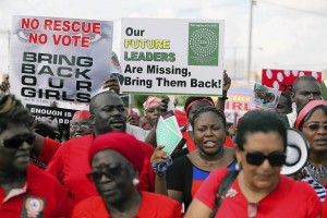 People hold signs during a protest demanding the release of abducted secondary school girls from the remote village of Chibok, in Lagos