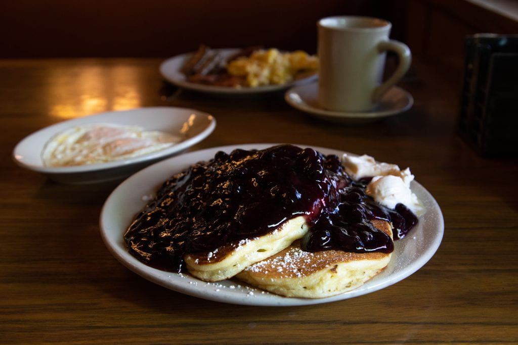 plate of pancakes with blueberry topping