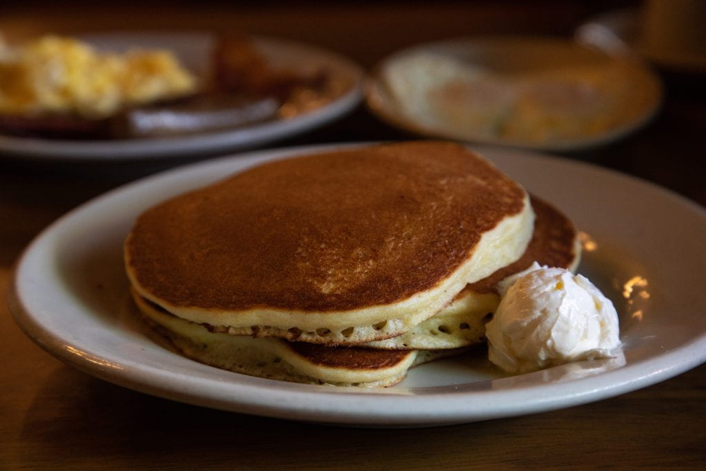 plate of pancakes with ice cream on the side