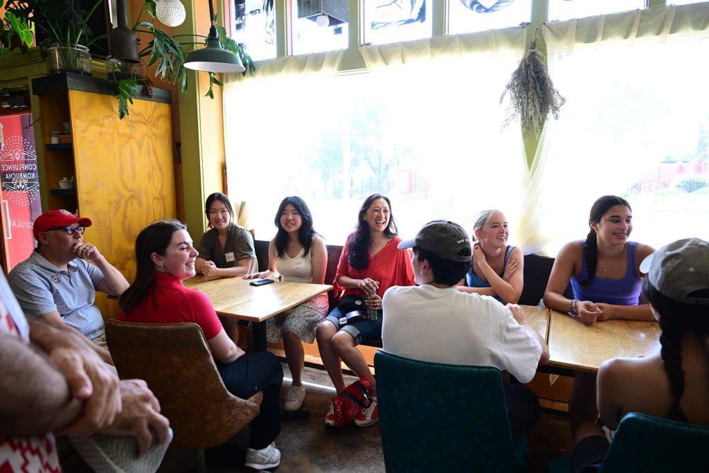 Dr. G and Chancellor Martin with students at table