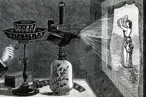 XJF440660 Magic Lantern projecting a maternal scene (engraving) by English School, (19th century); Private Collection; (add.info.: A popular form of entertainment in the Victorian era, the magic lantern was a precursor to moving pictures and modern day cinema; The lantern works by projecting light through a photographic slide which then passes through a lens, is magnified and projected onto a surface; The lantern in this image is powered by an oil lamp; Lanterns were often used for trickery, in particular to create the illusion of ghosts and dead spirits;); English, out of copyright