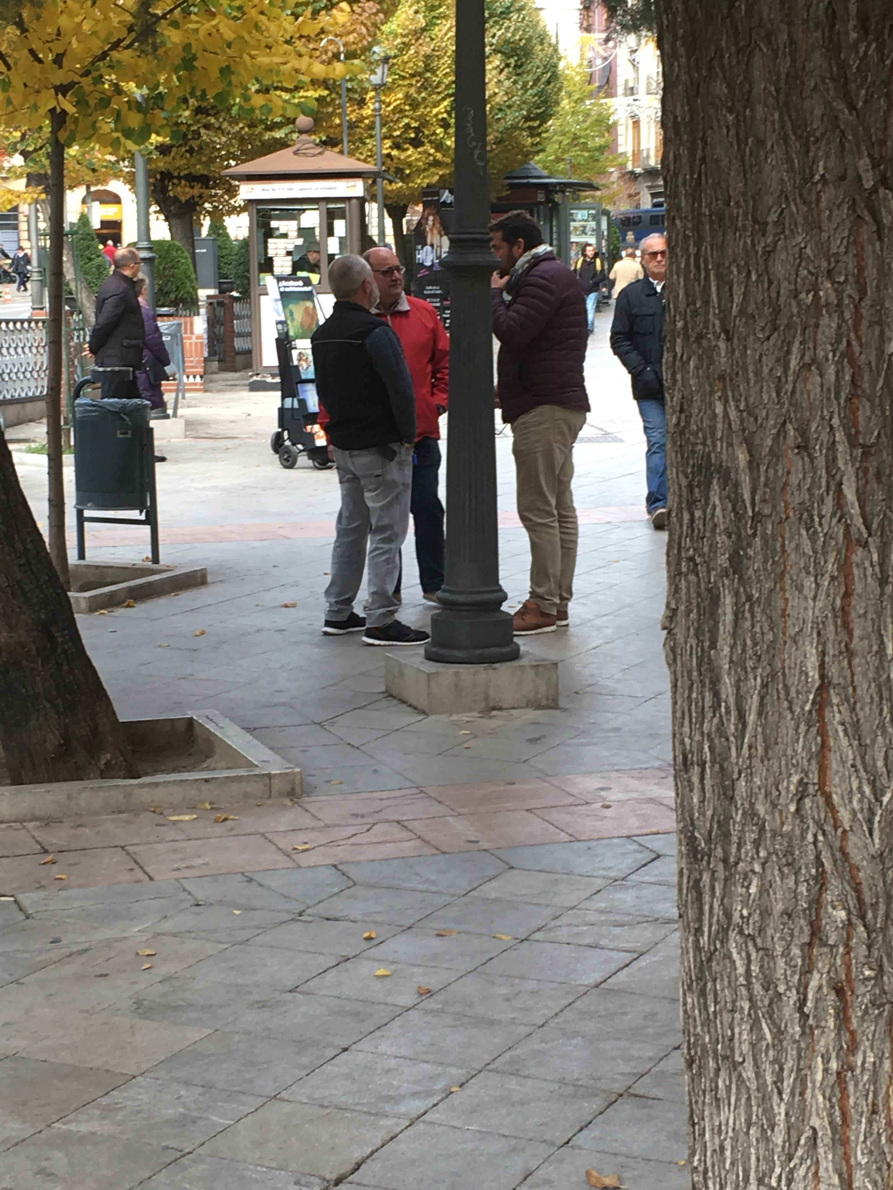 Small group of people standing around talking
